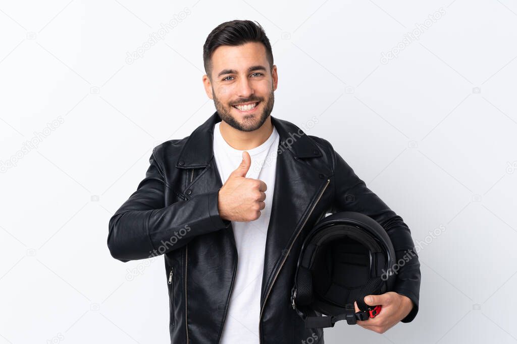 Man with a motorcycle helmet giving a thumbs up gesture