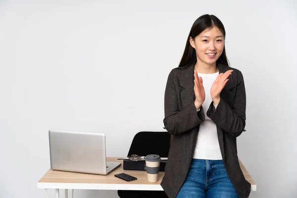 Business asian woman in her workplace isolated on white background applauding after presentation in a conference