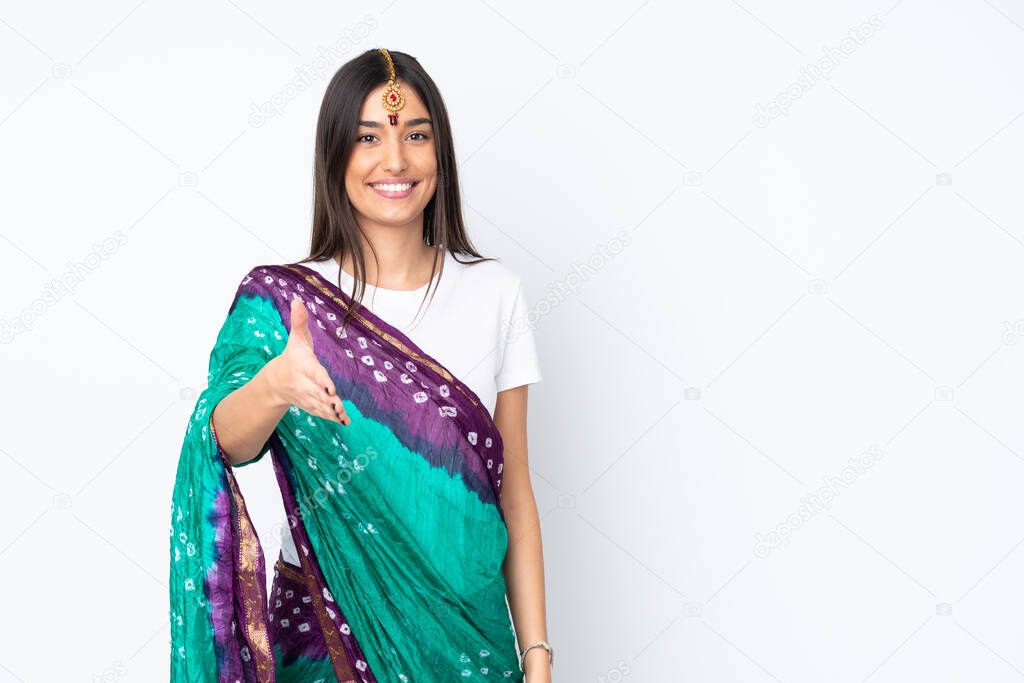 Young Indian woman isolated on white background shaking hands for closing a good deal