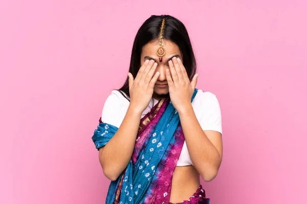 Young Indian woman with sari over isolated background with tired and sick expression