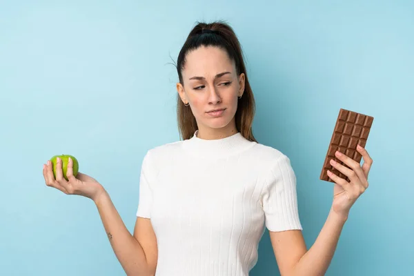 Young Brunette Woman Isolated Blue Background Having Doubts While Taking — 스톡 사진