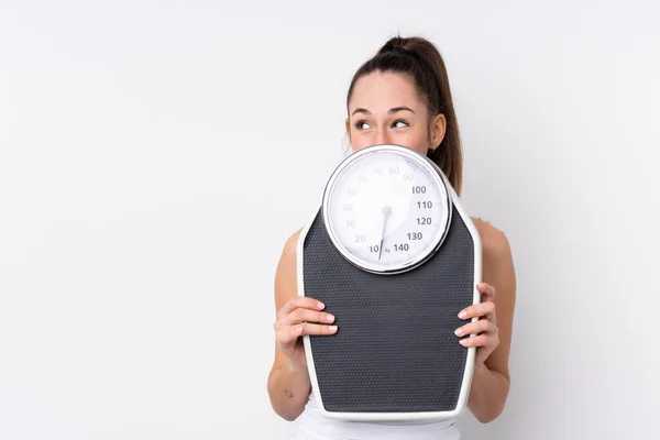 Young Brunette Woman Isolated White Background Weighing Machine Hiding — 스톡 사진