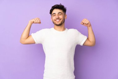 Soyutlanmış geçmişi olan yakışıklı Arap bir adam güçlü bir jest yapıyor.