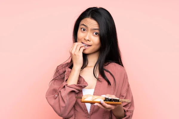 Teenager Asiatische Mädchen Essen Sushi Isoliert Auf Rosa Hintergrund Nervös — Stockfoto