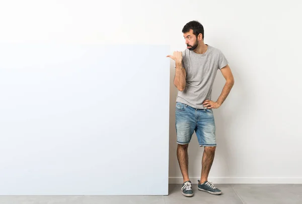 Young Handsome Man Beard Holding Big Blue Empty Placard Unhappy — Stock Photo, Image