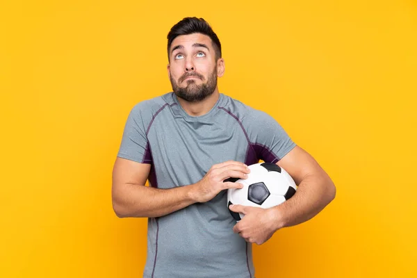 Football Player Man Isolated Background Making Doubts Gesture While Lifting — Stock Photo, Image