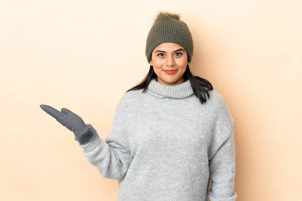 Young Colombian Girl Winter Hat Isolated Beige Background Holding Copyspace — Stock Photo, Image