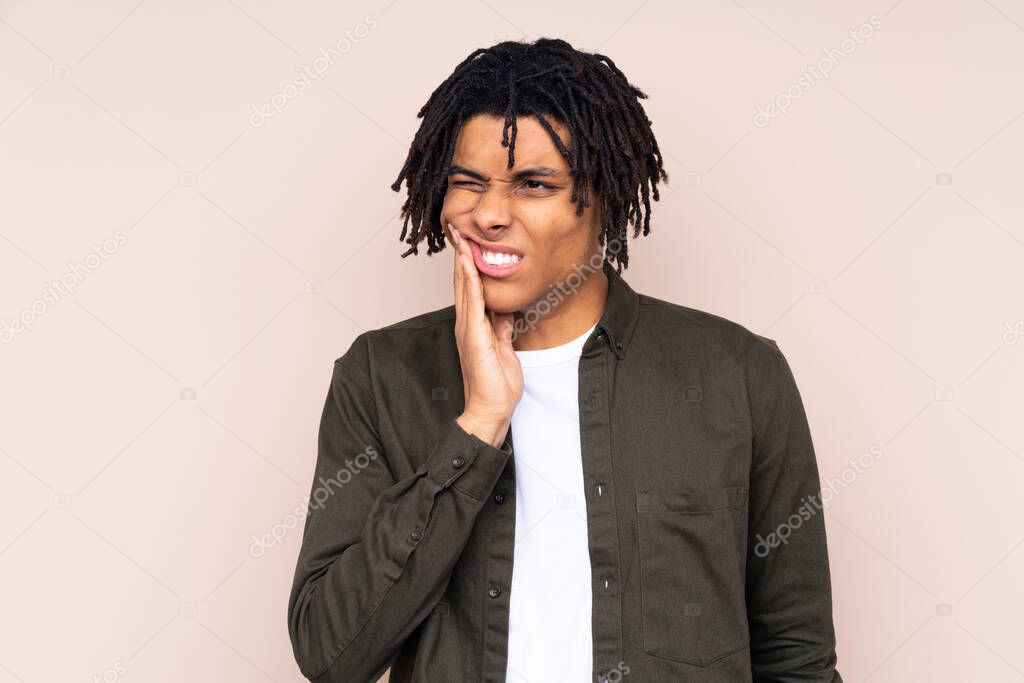 Young African American man over isolated background with toothache