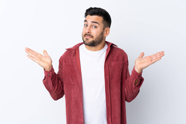 Young handsome man with beard wearing a corduroy jacket over isolated white background making doubts gesture