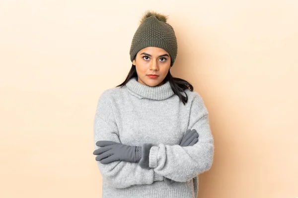 Young Colombian Girl Winter Hat Isolated Beige Background Keeping Arms — Stock Photo, Image