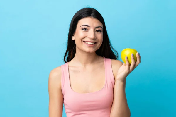 Young Brunette Girl Isolated Blue Background Apple — Stock Photo, Image