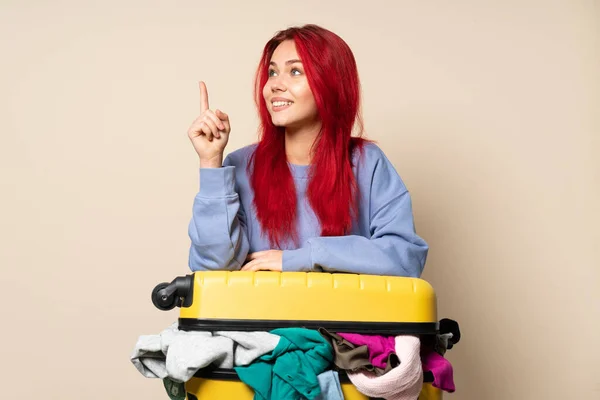 Traveler Girl Suitcase Full Clothes Isolated Beige Background Pointing Great — Stock Photo, Image