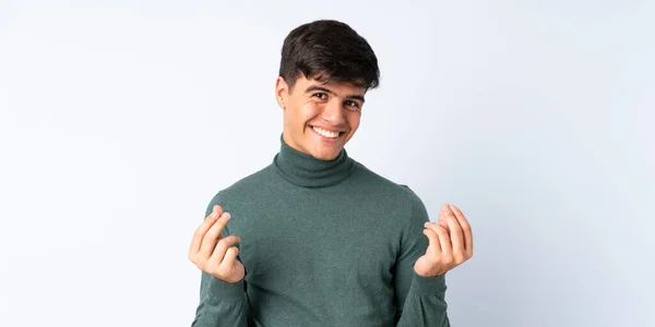 Hombre Guapo Sobre Fondo Azul Aislado Haciendo Gesto Dinero —  Fotos de Stock