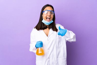 Koronavirüs hastalığını tedavi eden bir aşıyı araştıran bilim adamı kadın baş parmak işareti yapıyor.