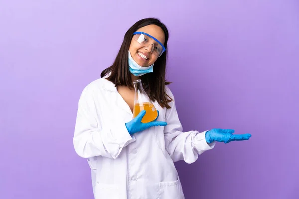 Scientist woman investigating a vaccine to cure coronavirus disease holding copyspace imaginary on the palm to insert an ad