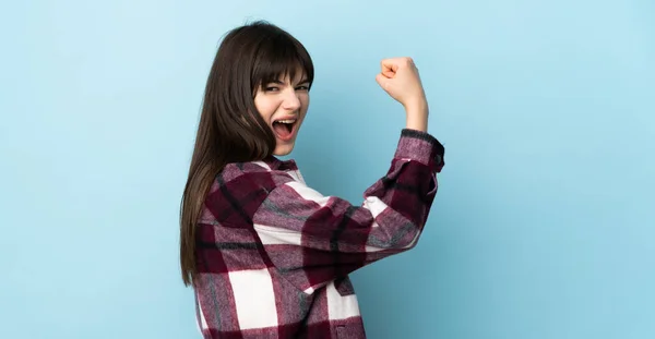 Teenager Ukrainian Girl Isolated Blue Background Doing Strong Gesture — Stock Photo, Image