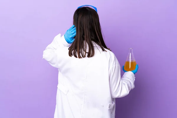 Scientist woman investigating a vaccine to cure coronavirus disease in back position and thinking