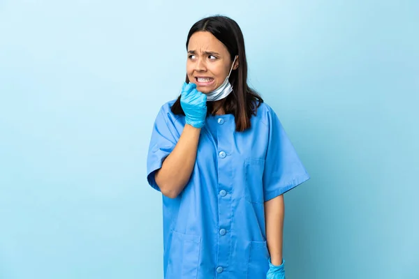 孤立的蓝色背景上的外科医生女人紧张而害怕 — 图库照片