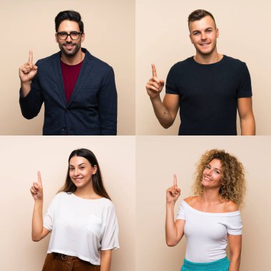 İzole edilmiş arka planda bir grup insan en iyinin işareti olarak parmağını kaldırıyor ve gösteriyor.