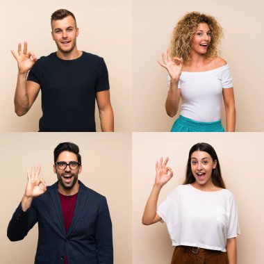 İzole edilmiş arka planda şaşırmış ve iyi işaretler gösteren bir grup insan