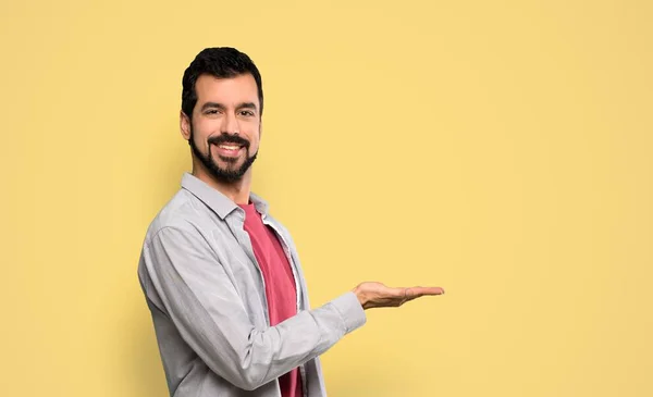 Handsome Man Beard Presenting Idea While Looking Smiling Isolated Yellow — Stock Photo, Image