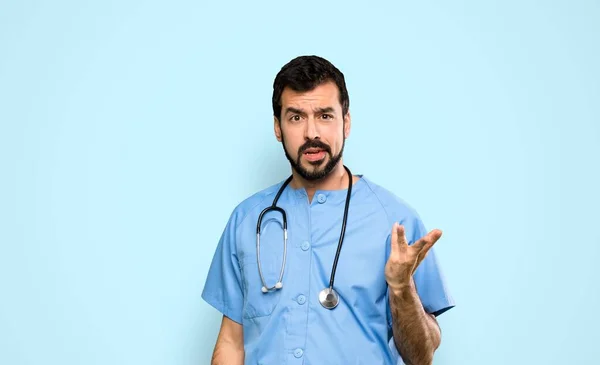 Surgeon Doctor Man Making Doubts Gesture Isolated Blue Background — Stock Photo, Image