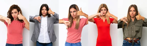 Conjunto Mulheres Jovens Sobre Fundo Branco Fazendo Bom Mau Sinal — Fotografia de Stock