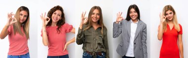Beyaz arka plandaki bir grup genç kadın parmaklarıyla işaret veriyor.