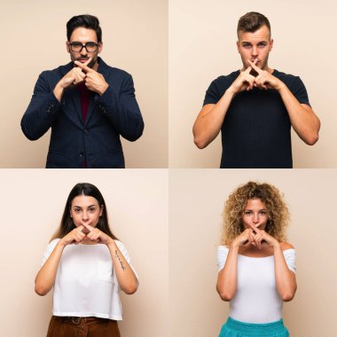 İzole edilmiş arka planda bir grup insan sessizlik işareti gösteriyor.