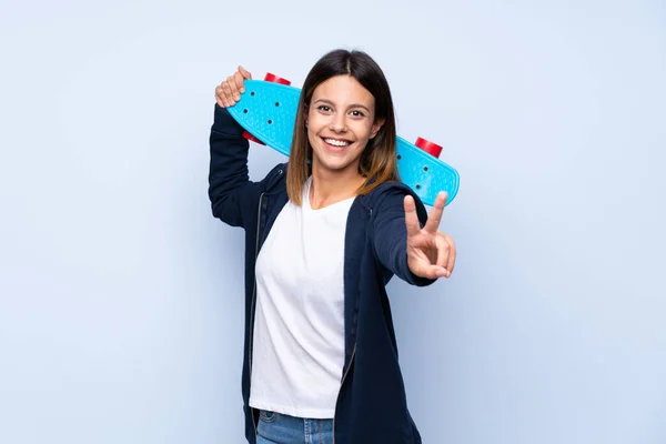 Young Woman Isolated Blue Background Skate Making Victory Gesture — 图库照片