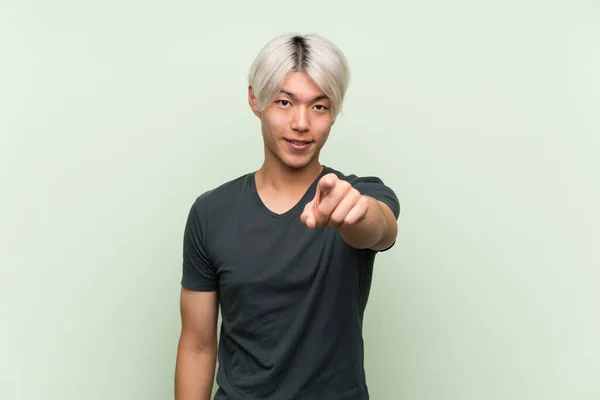 Mladý Asijský Muž Přes Izolované Zelené Pozadí Překvapen Ukazuje Dopředu — Stock fotografie