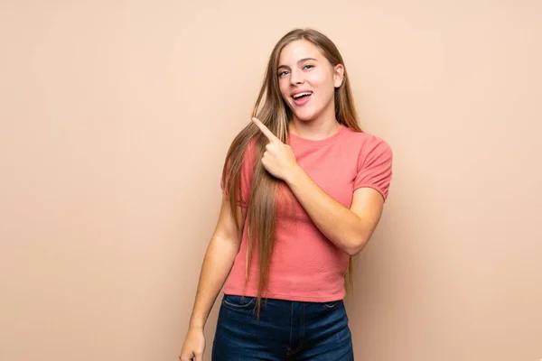 Teenager Blondýny Dívka Přes Izolované Pozadí Ukazující Prstem Stranu — Stock fotografie
