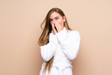 Bornozlu genç bir kız izole bir arka planı var ve yüzünde sürpriz bir ifade var.