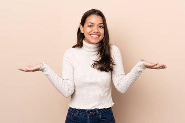 Young Colombian girl over isolated background with shocked facial expression