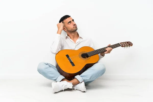 Young Man Sitting Floor Guitar Having Doubts Confuse Face Expression — Stock Photo, Image