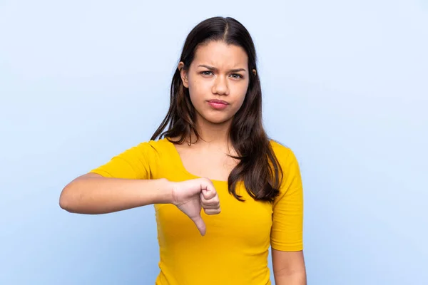 Young Colombian Girl Isolated Blue Background Showing Thumb Sign — Stock Photo, Image