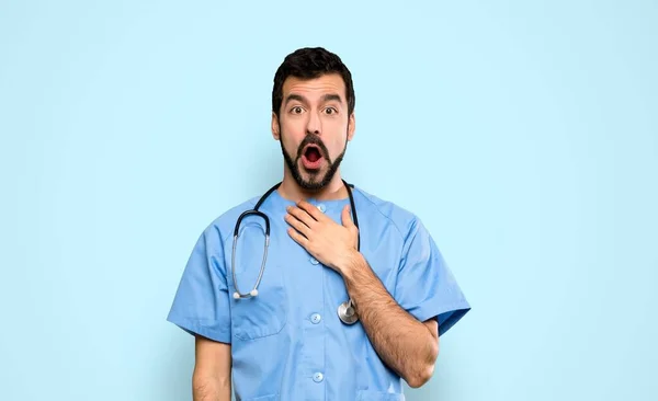 Chirurg Lekarz Człowiek Zaskoczeniem Wyraz Twarzy Odizolowanym Tle Niebieski — Zdjęcie stockowe
