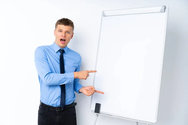 Young Businessman Giving Presentation White Board Surprised Pointing Side — ストック写真