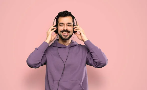 Schöner Mann Mit Sweatshirt Der Musik Über Isoliertem Rosa Hintergrund — Stockfoto