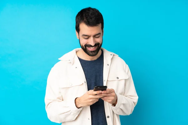 Joven Hombre Guapo Con Chaqueta Pana Blanca Sobre Fondo Azul —  Fotos de Stock