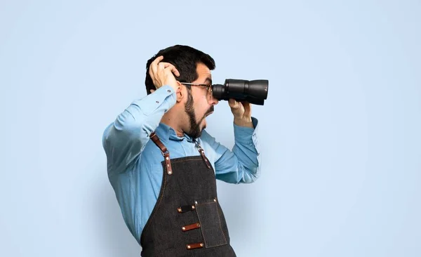 Man Apron Binoculars Isolated Blue Background — Stockfoto