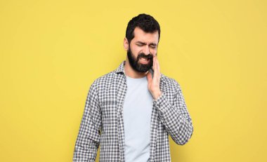 Dişi ağrıyan sakallı yakışıklı bir adam.