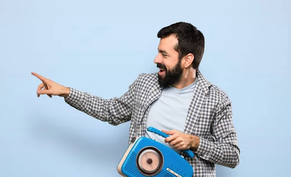 Hombre Guapo Con Barba Sosteniendo Una Radio Sobre Fondo Azul —  Fotos de Stock