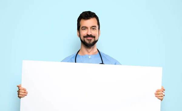 Surgeon Doctor Man Holding Empty Placard Isolated Blue Background — Stockfoto