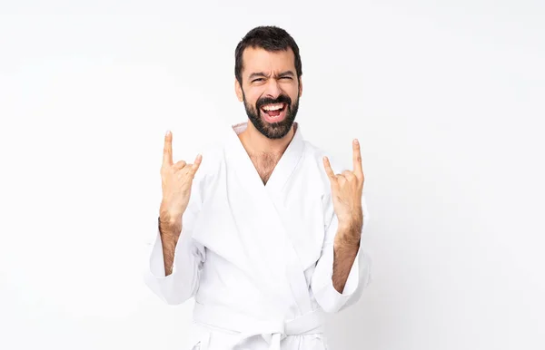 Joven Haciendo Karate Sobre Fondo Blanco Aislado Haciendo Gesto Roca —  Fotos de Stock