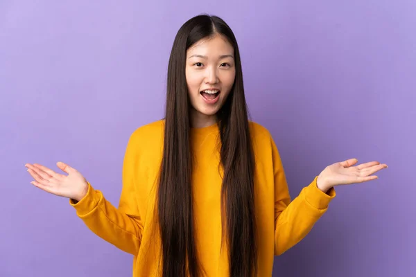 一个年轻的中国女孩 有着震惊的面部表情 背过了孤立的紫色背景 — 图库照片