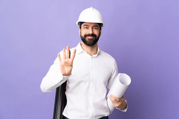 Jovem Arquiteto Homem Com Capacete Segurando Plantas Sobre Fundo Roxo — Fotografia de Stock