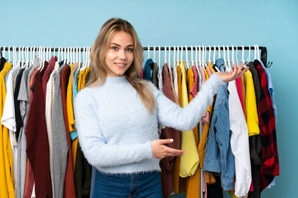 Adolescente Ragazza Russa Comprare Alcuni Vestiti Isolati Sfondo Blu Allungando — Foto Stock
