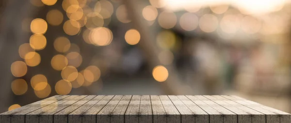 Empty wooden table top with lights bokeh on blur restaurant background, 3D Rendering.