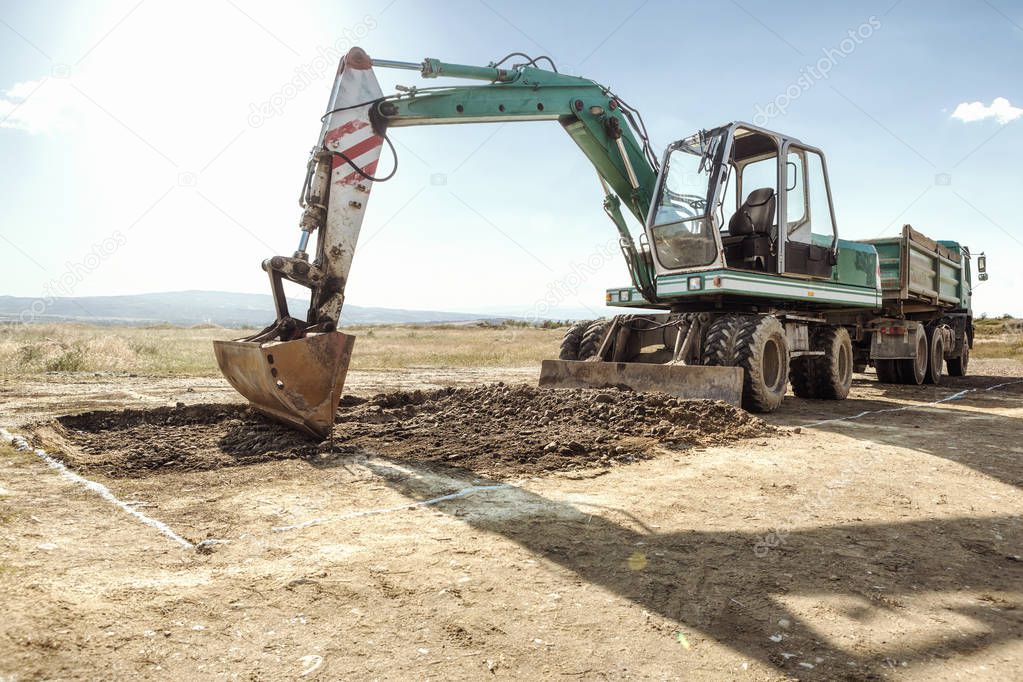 Excavator and truck on a construction site